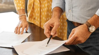 couples signing postnup agreement