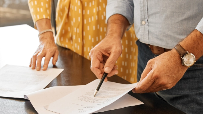 couples signing postnup agreement